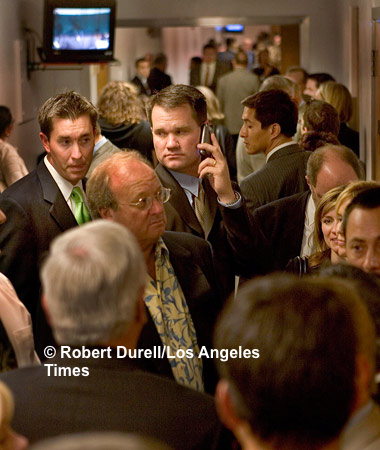 THIRD HOUSE --- As the legislative session ends, the most crowded spot in the Capitol is always the hallway at the rear-entrance to the Assembly and Senate floors. This is the domain of the so-called Third House. Jammed with lobbyists hoping to turn a vote or two at the last minute, looking up at closed circuit TVs of the proceedings inside or scribbling notes on the back of business cards to send to legislators via the sergeants-at-arms, the corridor takes on a life of its own.  I remember the area having the humidity of a sauna: too many bodies in too small space working much too hard. August 31, 2006.
