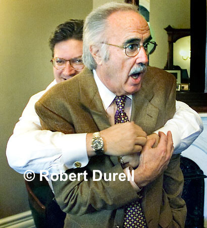 THE HUG --- Even a press conference can be an opportunity to take a good photo, but that photo is almost never the person on the podium at the microphone. I try to arrive at press conferences half an hour early and watch people as they come in. When Assembly Speaker Robert Hertzberg showed up for a formal conference, he didn't walk straight to the microphones. With my back turned to the door, I head some noise whipped around and started shooting as Hertzburg bearhugged a surprised Senate President John Burton. The embrace was over in a seconds.
February 4, 2000.