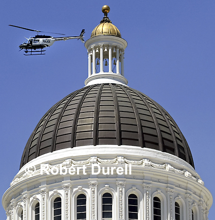 THE DOME ---It is unusual to see a police helicopter flying so low and so close to the Capitol dome, but this day protesters were clashing with police over production of genetically-modified food. Even with so much going on down below, my attention was drawn upward to the majestic dome, the blue sky and what seemed like the building's protector.
June 23, 2003