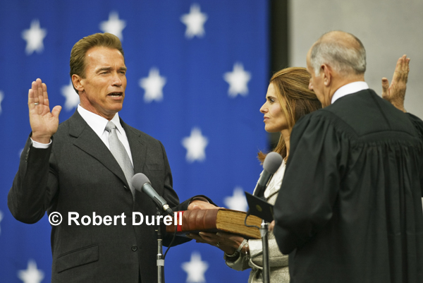 OATH --- Ceremonial photographs tend to be rather mundane. This one wasn't. The historic Recall election was over. Gov. Arnold Schwarzenegger was inaugurated Hollywood-style against a brilliant background of white stars on a blue background. People who have seen this photograph say it is so vivid, they can hear Schwarzenegger's voice. November 17, 2003.
