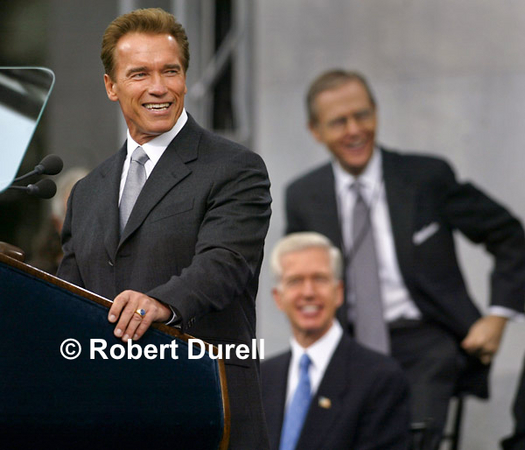 GENERATIONS --- On inauguration day after the Recall election, would it be possible to get into one frame Governor Schwarzenegger, his predecessor Gray Davis, and former governor Pete Wilson? Two of the three are career politicians, who recognize the value of appearances, so I was hopeful. I was stuck on a riser about 175 feet away on the main photo platform with a 400 millimeter lens. I watched and waited as Pete Wilson moved around the stage. When he perched behind Davis, I captured the moment. Sometimes even the best planning benefits from an assist by Lady Luck.
November 17, 2003