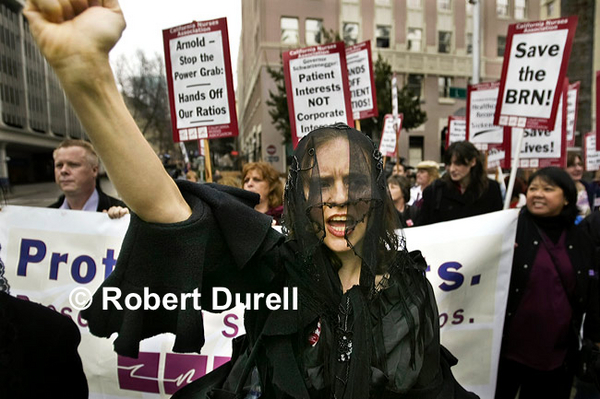 MOURNING CUTS --- Even on the slowest of news days, I could almost always count on at least one protest on the Capitol grounds. On this cold day, I watched for almost 15 minutes as sign-carrying protesters filed by me on L Street, then onto the grounds.  I had only shot a couple of frames when I saw this woman in black veil -  the traditional mark of a widow in Mexico. Nurses were protesting a possible increase in the permissible nurse-to-patient staffing levels in hospitals. She was shouting louder than anyone else and suddenly raised her fist defiantly and I raised my camera above my head. The message was clear and dramatic: fewer nurses would imperil patients. This remains one of my favorite protest photos.
January 18, 2005

