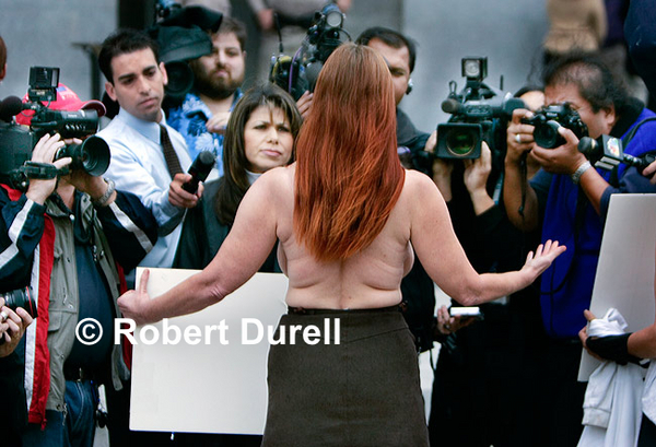 BREASTS NOT BOMBS --- While there have been numerous anti-war protests at the Capitol since late 2001, none drew as much press as "Breasts Not Bombs," for which two women stripped to the waist at the west entrance to the Capitol to protest the U.S. war in Iraq and Afghanistan. Shortly after this photo was taken, both were led away by CHP officers. Sometimes it is best to stand away from the media scrum, to be the counterpoint. I could have shot this from the front, focusing on shoulders up, but the earnest expressions of the journalists seemed to capture the impact of the protest best.
November 7, 2005