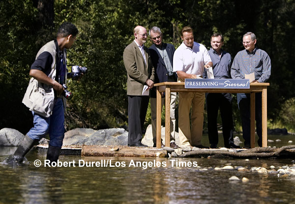 WADER --- What is the reality of a event? Do you show the full setting of a press conference or do you zero on just what you would expect to see? Here the answer was obvious: show the whole scene. While Gov. Schwarzenegger signed legislation to create the Sierra Nevada Conservancy on the banks of Bear Creek near Colfax, his photographer, prepared with rubber boots, waded in to get a better shot.
September 23, 2004

