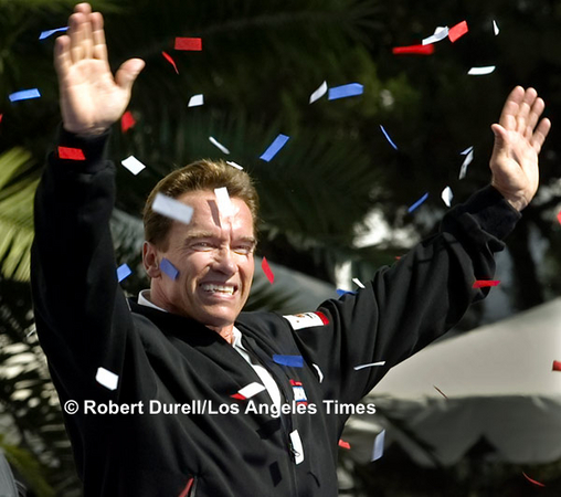 RUNNING MAN --- The terminus of gubernatorial candidate Governor Arnold Schwarzenegger's statewide Recall bus tour was, naturally, Sacramento. What better way to end the theatrical campaign than a confetti-strewn celebration on the Capital steps. But this warm autumn day, the small bits of paper kept sticking to his face, not part of the script. 
October 5, 2003. 


