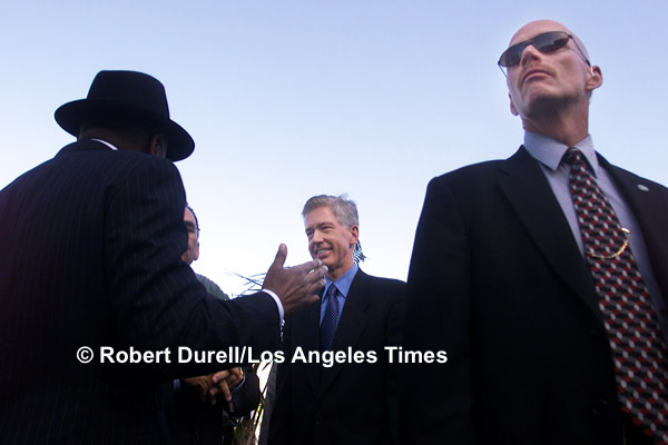 GUARDED --- As part of his plan to deal with the energy crisis in 2001, Gov. Gray Davis met with Mayor Willie Brown and other Bay Area mayors to encourage them to cut their cities' electric consumption by 20 percent. The photograph has nothing to do with the energy shortfall, but it gives the feeling of what it is like to be an elected official: you are rarely alone, often inside the security bubble and insulated from your surroundings. Willie Brown in his black Fedora, Davis hatless, both guarded by one of Davis' security detail.
April 30, 2001
