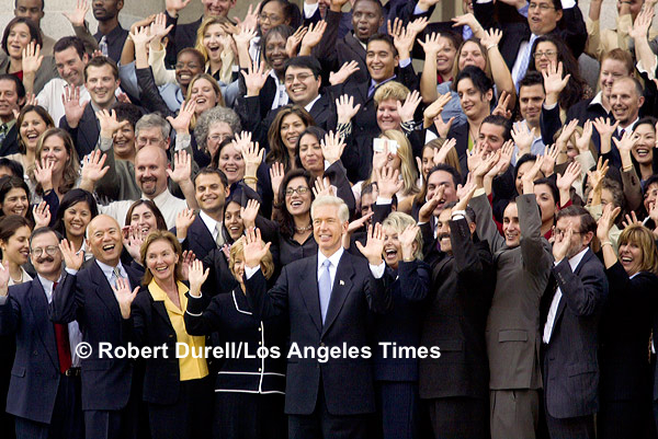 FAREWELLS --- I passed a colleague on L Street, the street with the best view of the Capitol, one morning and he mentioned that he had seen a group of Gray Davis staffers gathering around the corner on the east steps of the Capitol. It was just a couple days after Davis had lost in the Recall election and they wanted one last photo of themselves with their boss. I shot plenty of emotional images that morning - lots of crying, lots of hugging - but this is the one I liked best because it illustrates the resiliency of the human spirit. People were upbeat, ready to move on.
October 9, 2003

